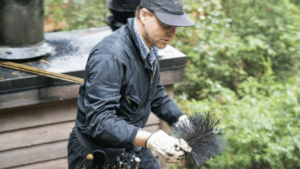 chimney sweep attaching brush to extension