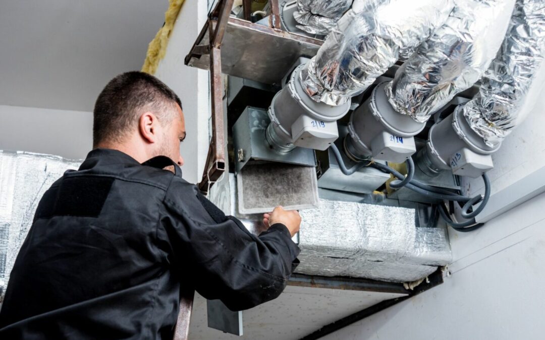 An expert in HVAC dampers works on a commercial system